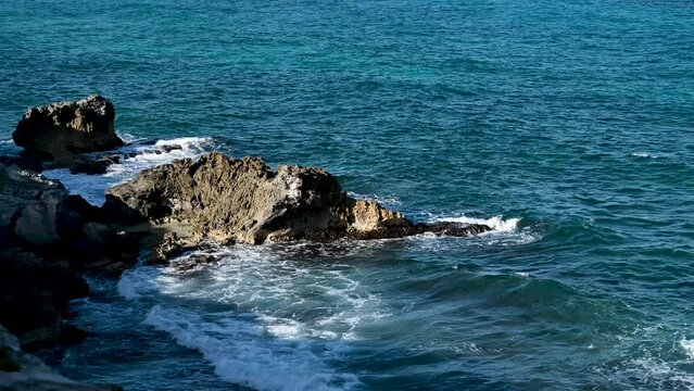 Waves crashing against rocks off the coast of Isla Mujeres in Punta Sur Mexico