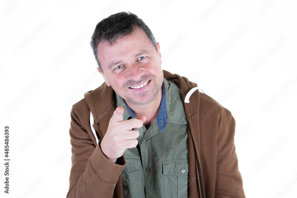 Wall mural smiling man handsome points finger in white background