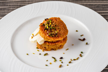 Bread kadayif or Ekmek Kadayifi with cream, a delicious Turkish dessert served in a fine dining restaurant