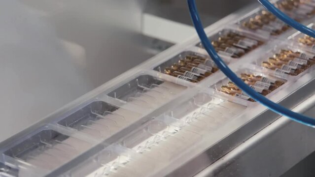 Packaging of hermetically sealed ampoules in a pack. The work of high-tech systems in pharmacology.