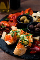 Fototapeta na wymiar bruschetta with salmon close-up, Italian tosted bread with salmon and cheese