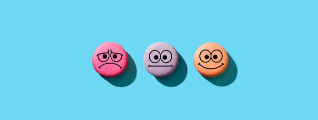 Colorful macarons with happy, neutral and sad faces. Customer rating and evaluation