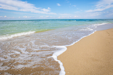 Beautiful bright colorful tropical summer background. Soft turquoise blue ocean wave on golden sandy beach.