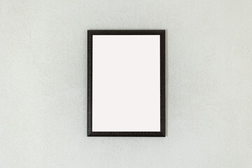 Vertical white frame mockup on white wall.