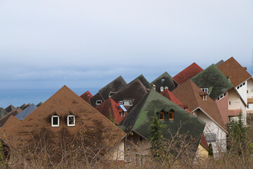 interesting view over the harbor district, at the harbor of trabzon there are colored houses with...