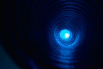 Defocused neon glow. Futuristic background. Fantasy tunnel. Blur fluorescent blue color round...