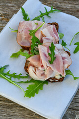 Home made healty Ketogenic diet sandwich fromWholegrain low carb bread, smoked bacon and arugula.
