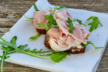 Home made healty Ketogenic diet sandwich fromWholegrain low carb bread, smoked bacon and arugula.