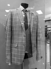 Mannequin of a man in a suit on a display case in a market.