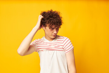 cute red-haired guy putting on a striped t-shirt posing isolated background unaltered