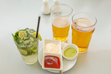 glass of lemonade with lime and mint with chilled beer.