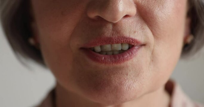 Cropped close up view lower part of face older confident woman mouth talking, makes speech to camera, express opinion, makes announcement, gives advice, say text, provide helpful information concept