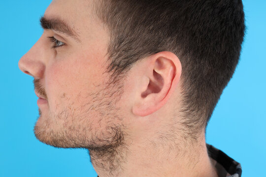 Side view photo of young man head on blue background