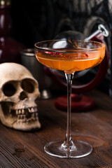 Red hot chili peppers and vodka in glass on table