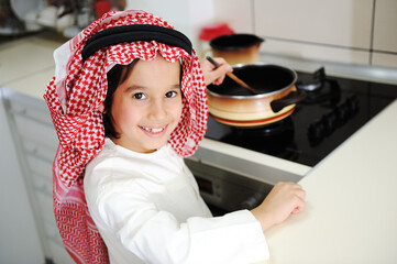 Little kid boy is cooking , high quality photos