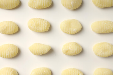 Raw potato gnocchi on white background, close up