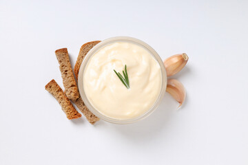 Garlic sauce, ingredients and snacks on white background