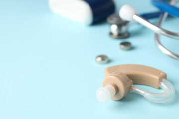 Concept of health care with hearing aid on blue background