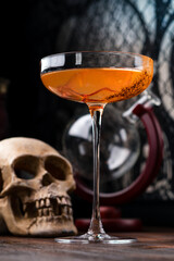 Red hot chili peppers and vodka in glass on table