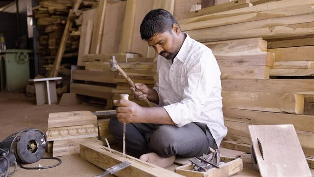 woodworker busy working with carpentry tools at shop - concept of artisans, self-employment and small business