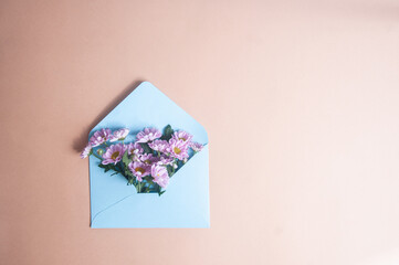 Light blue envelope with flowers and copy space valentines day spring concept womens day flat lay