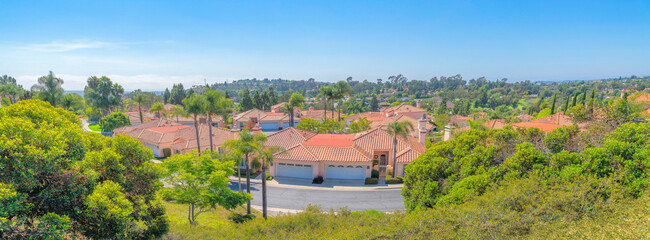 View of houses with white garage doors near the road at San Marcos, San Diego, California