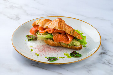 Croissants with soft cheese, salted salmon and green salad