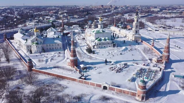 Aerial view in winter of the old Epiphany Staro-Golutvina monastery on the outskirts of the city of Kolomna and residential areas in the distance, Russia.