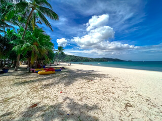 Blue Skies white Sandy Beach and turquoise waters of Patong Beach Phuket Thailand