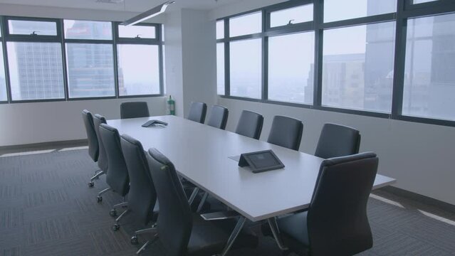 Panning Shot Of A Stylish And Modern Meeting Room In A Corporate Office With Buildings Outside View