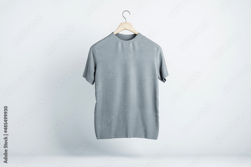 Aufkleber blank grey t-shirt hanging in the air with copyspace for your text on light backdrop. 3d rendering, 
