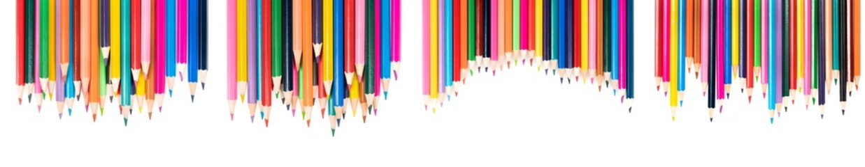 Wooden colored pencils isolated on a white background. A line of multicolored pencils in a large plan