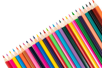 Wooden colored pencils isolated on a white background. A line of multicolored pencils in a large plan