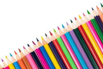 Wooden colored pencils isolated on a white background. A line of multicolored pencils in a large plan