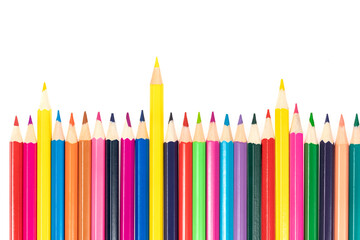 Wooden colored pencils isolated on a white background. A line of multicolored pencils in a large plan