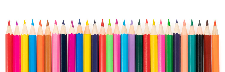 Wooden colored pencils isolated on a white background. A line of multicolored pencils in a large plan