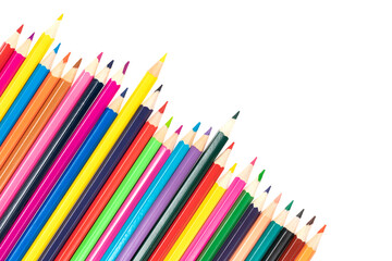 Fototapeta premium Wooden colored pencils isolated on a white background. A line of multicolored pencils in a large plan
