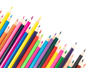 Wooden colored pencils isolated on a white background. A line of multicolored pencils in a large plan