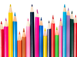 Wooden colored pencils isolated on a white background. A line of multicolored pencils in a large plan