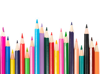Wooden colored pencils isolated on a white background. A line of multicolored pencils in a large plan