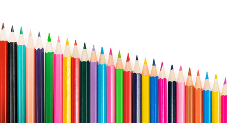 Wooden colored pencils isolated on a white background. A line of multicolored pencils in a large plan