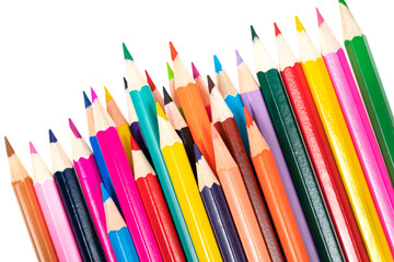 Wooden colored pencils isolated on a white background. A line of multicolored pencils in a large plan