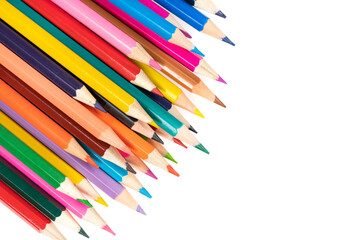 Wooden colored pencils isolated on a white background. A line of multicolored pencils in a large plan