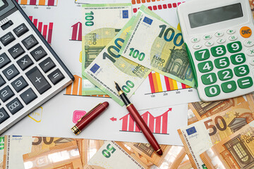 new various graphs pen calculator arranged on new euro banknotes