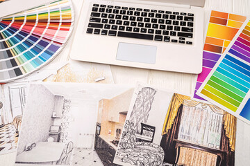 color palettes and new designs of sketches of apartments are laid out in an axis on the table.