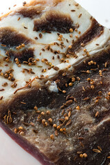 raw pork belly with skin with spices and herbs