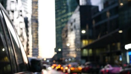 Defocused cars lights on road in twilight, vehicles traffic on megapolis street. Urban downtown, business or financial district of Moscow, Russia. Transport driving in evening dusk. Big city life.