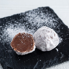 round candy made of milk chocolate in powdered sugar