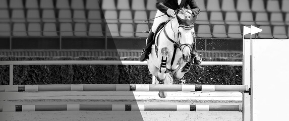 Horse and rider in uniform performing jump at competition, black and white.
