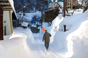 old man walking on snow covered road.Artvin. Turkey